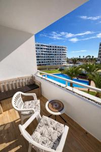 a balcony with two chairs and a table at Apartamento Luxury in Maspalomas