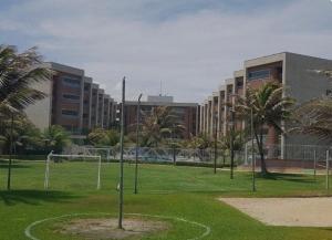 a park with a soccer field in front of a building at Apartamento térreo no Morro Branco Marina II in Beberibe