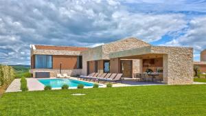a house with a swimming pool in the yard at Deluxe Villa with heated pool in Brtonigla