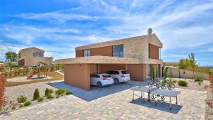 a house with a car parked in front of it at Deluxe Villa with heated pool in Brtonigla