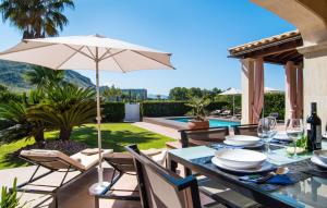 a patio with a table and an umbrella at Montelago in Alcudia