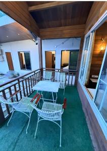 a table and chairs on the balcony of a house at Royal cottage by royale palace in Mount Ābu