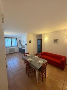 a living room with a red couch and a table at La Dimora dei Cri in Cona