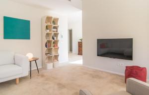 a living room with a television and a couch and a table at Ternelles in Pollença