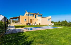 a house with a swimming pool in the yard at Finca Llum in Manacor