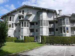 a large apartment building with a lawn in front of it at Appartement am Schlatterberg in Altenmarkt im Pongau