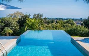 a swimming pool with blue water and trees at Son Sard Nou in Son Servera