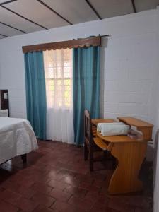 a room with a table and a bed and a window at Coco Beach House in Coco +46 photos