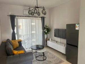 a living room with a couch and a tv at Naledi Inn in Gaborone