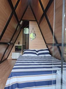 a bedroom with a large bed in a tent at Cantinho do Chalé in Jaboticatubas
