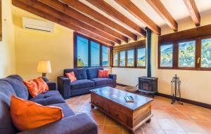 a living room with blue couches and a wood stove at Antonio in Deia +29 photos