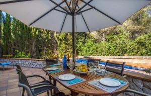a wooden table with an umbrella on a patio at Cocodrilo in Alcudia