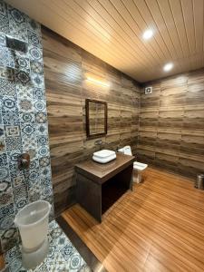 a bathroom with a sink and a toilet in a room at Royal cottage by royale palace in Mount Ābu +12 photos