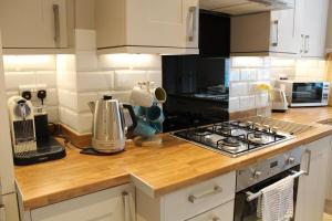 a kitchen with a counter top with a stove top oven at No 1 Chapel Row in Bakewell