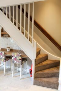 a staircase in a house with a table and chairs at No 1 Chapel Row in Bakewell +26 photos