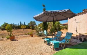a group of chairs and an umbrella in a yard at Cas Nets in Llucmajor +39 photos