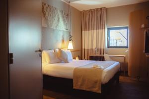 a hotel room with a bed and a window at Atlantis Alger Aéroport ex Ibis in Alger