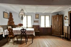 a dining room with a table and two chairs at Chez Oma, La petite ferme in Weinbourg +45 photos