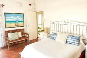 a bedroom with a bed and a chair at Verdoesie Jacobsbaai in Jacobs Bay