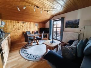 a living room with a couch and a table at Ferienwohnung Soiernblick Krün Bärnbichl in Krün