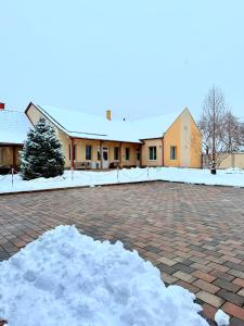 a pile of snow in front of a building at Eszter Apartman in Békéscsaba