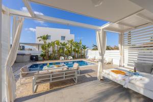 a villa with a swimming pool and a patio at Protaras Villa Alina in Protaras