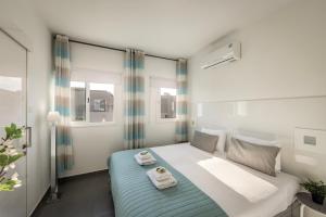 a bedroom with a bed with towels on it at Protaras Villa Alina in Protaras +34 photos
