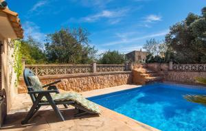 a chair sitting next to a swimming pool at Moli De Ca N'orell in Santanyi