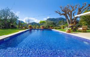 a swimming pool with blue water in a yard at Can Sion in Esporlas