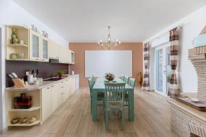 a kitchen with a table and chairs in a room at Villa Luce in Labin