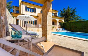 a villa with a swimming pool and a house at Ca Nostra in Cala Millor