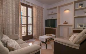 a living room with two couches and a television at Roser De Arta in Artá