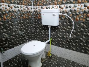 a bathroom with a white toilet in a room at Luv Kush Homestay Ayodhya call now- 75659-24844 in Ayodhya