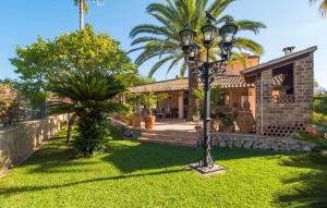 a house with a street light in front of a yard at Casa Romantica De Sa Coma in Sa Coma +44 photos