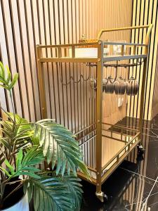 a bird cage with a plant in front of a fence at Jacuzzi des Voutes in Vesoul