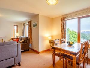 a living room with a table and a couch at 4 Bed in Gairloch oc-ca390 in Strath
