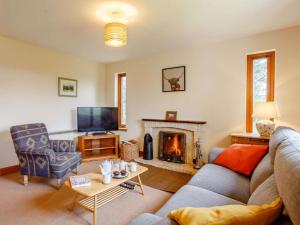 a living room with a couch and a fireplace at 4 Bed in Gairloch oc-ca390 in Strath