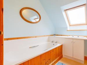 a bathroom with a tub and a sink at 4 Bed in Gairloch oc-ca390 in Strath +17 photos