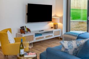 a living room with a tv on a wall at 2 Bed in Melplash oc-r30043 in Netherbury