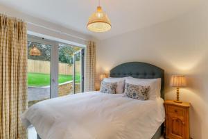 a bedroom with a bed and a large window at 2 Bed in Melplash oc-r30043 in Netherbury