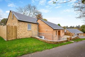 a brick house with a porch and a fence at 2 Bed in Melplash oc-r30043 in Netherbury