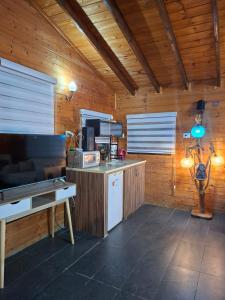 a room with a kitchen with wooden walls and a table at צימרים מול הנוף in Yarka
