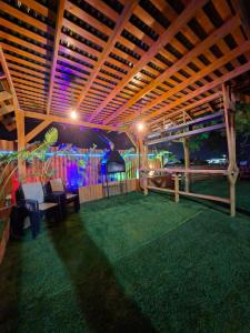 a covered patio with chairs and tables and lights at צימרים מול הנוף in Yarka +20 photos