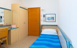 a small room with a bed in the corner at Hotel Brig in Cattolica