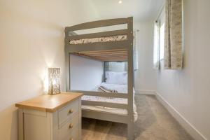a bunk bed in a room with a desk at 2 Bed in Bush oc-h31844 in Bude