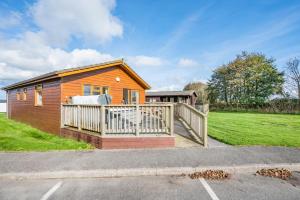 a small wooden house with a white fence at 3 Bed in St. Merryn oc-r30137 in Saint Merryn