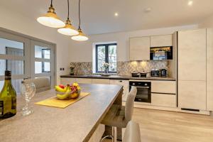 a kitchen with a table with a bowl of fruit on it at 2 Bed in St. Ives oc-s28155 in St Ives