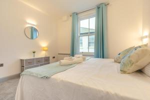a bedroom with a large white bed with a window at 2 Bed in St. Ives oc-s28155 in St Ives
