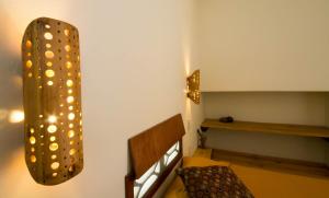 a room with a bench and a light on the wall at Red Pepper Popoyo in Popoyo