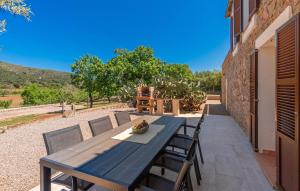 a blue wooden table and chairs on a patio at Can Cremat in Artá +34 photos
